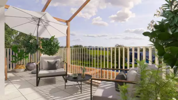Perspective 3D d'une terrasse d'un appartement lumineuse et accueillante. Un coin salon d'extérieur aménagé avec deux fauteuils confortables, une petite table ronde et un parasol blanc.