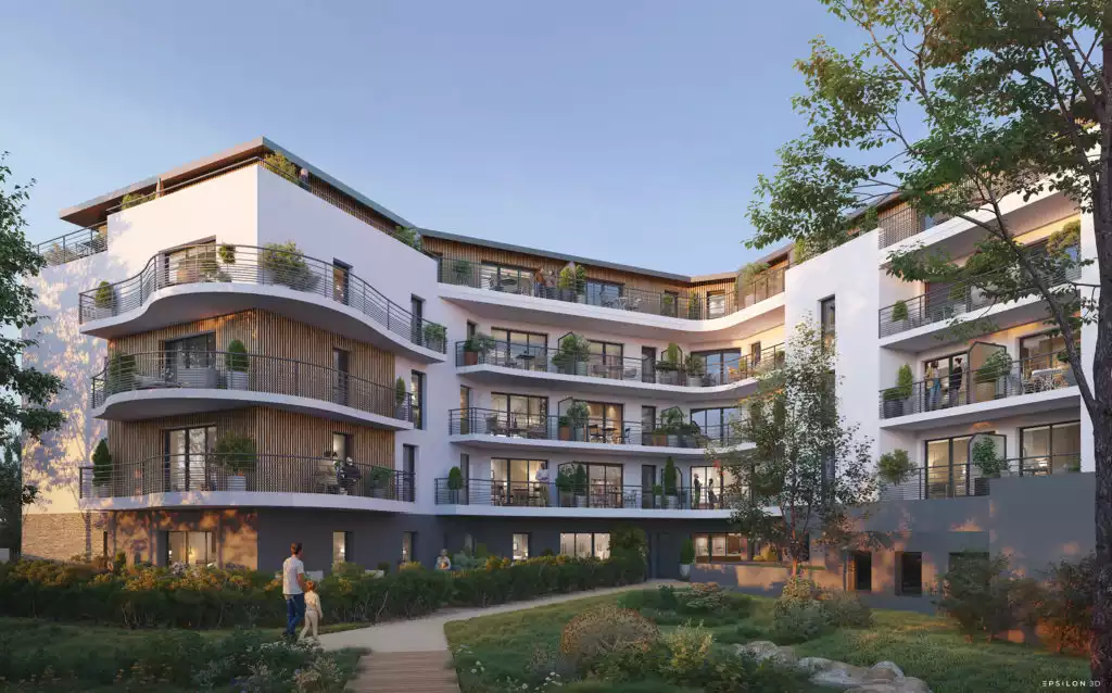 une architecture moderne et intégrée à son environnement. Le bâtiment principal est un complexe résidentiel de plusieurs étages, caractérisé par des façades blanches avec des éléments de bardage en bois et des balcons incurvés et verdoyants. Il offre des terrasses spacieuses au dernier étage avec des finitions en bois. L'aménagement paysager est soigné, incluant des espaces verts collectifs et des arbres matures, suggérant un cadre de vie urbain mais aéré. L'ensemble s'insère dans un quartier résidentiel existant, comme le montre la vue aérienne.
