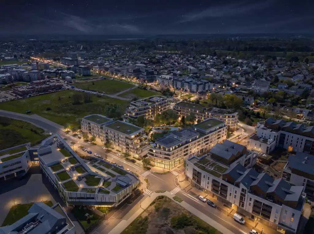 Un projet à travers une vue aérienne nocturne qui souligne l’insertion harmonieuse de l’îlot dans son tissu urbain.