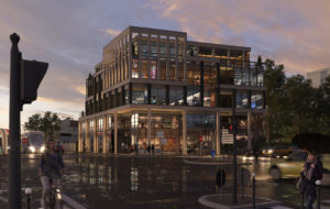 Un immeuble moderne à usage mixte bureaux et commercial dans un environnement urbain au niveau d'un carrefour. Le style architecturale avec de grandes surfaces vitrées.
