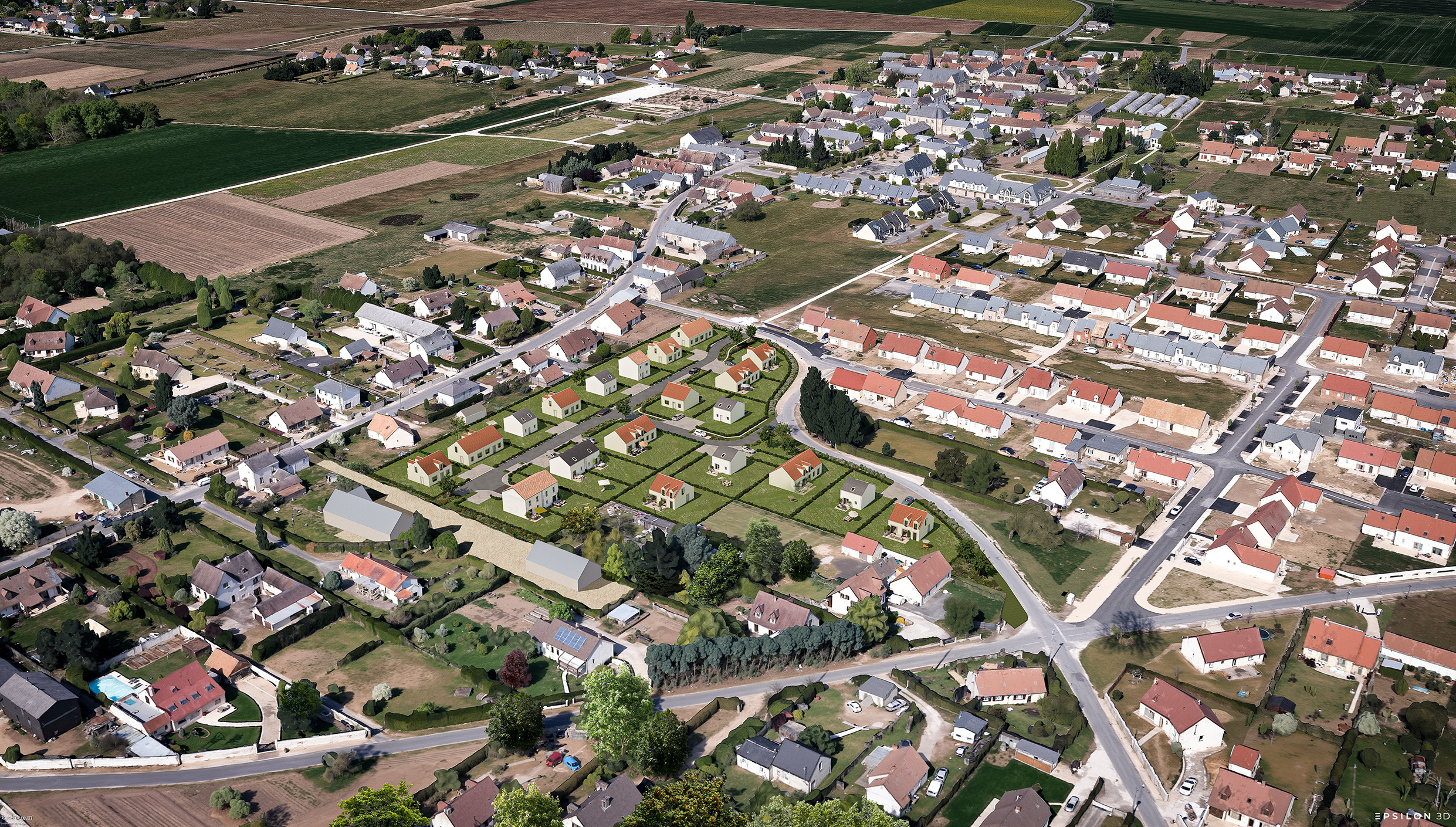 Vue en plongée d'une commune rurale, mettant en évidence l'insertion d'un nouveau lotissement au cœur du tissu urbain existant.