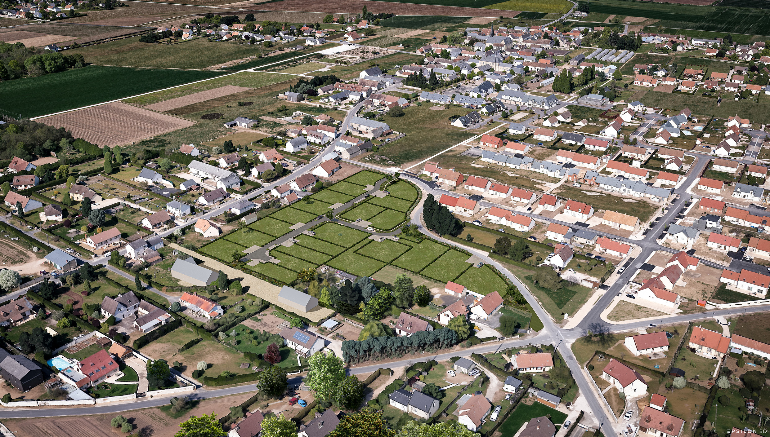 Vue en plongée d'une commune rurale, mettant en évidence l'insertion d'un nouveau lotissement au cœur du tissu urbain existant.